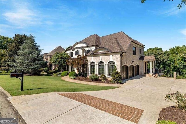 french country home featuring a front lawn