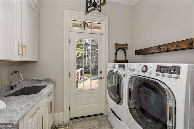 washroom with separate washer and dryer, cabinets, and sink