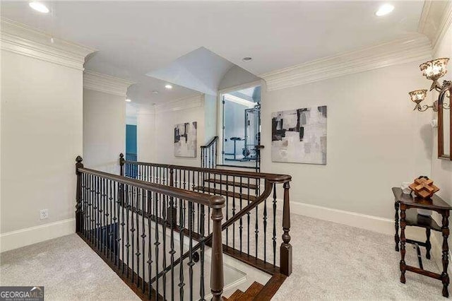 hall featuring ornamental molding and carpet floors