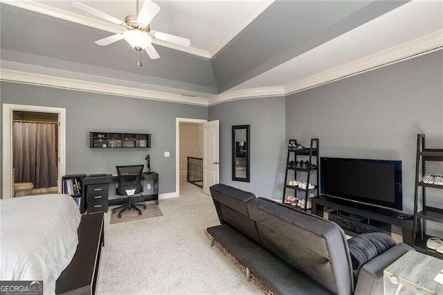 carpeted bedroom with ceiling fan, vaulted ceiling, and ornamental molding