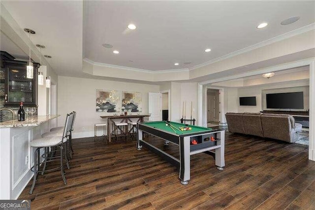 recreation room featuring a tray ceiling, dark hardwood / wood-style flooring, indoor bar, and pool table