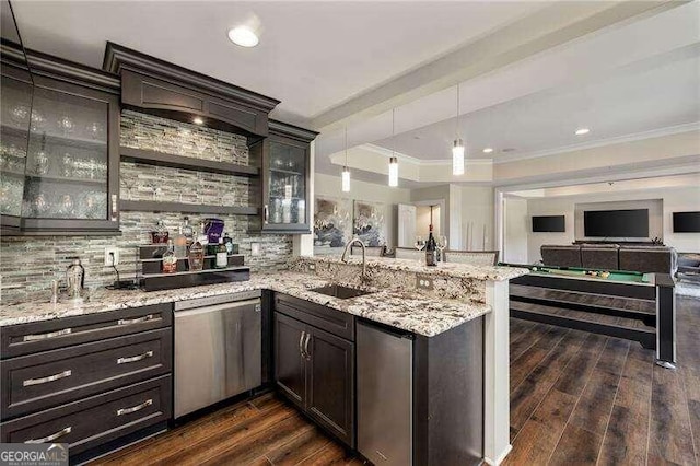 kitchen with crown molding, appliances with stainless steel finishes, light stone counters, sink, and dark hardwood / wood-style floors