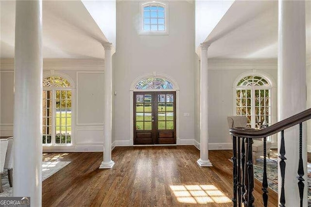 entryway featuring ornate columns, plenty of natural light, and french doors