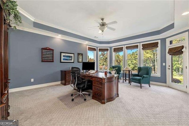 office area with a wealth of natural light, a raised ceiling, ceiling fan, and ornamental molding