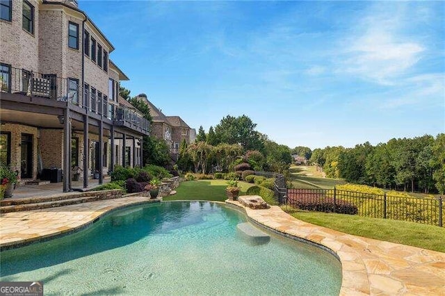 view of swimming pool featuring a patio area and a yard