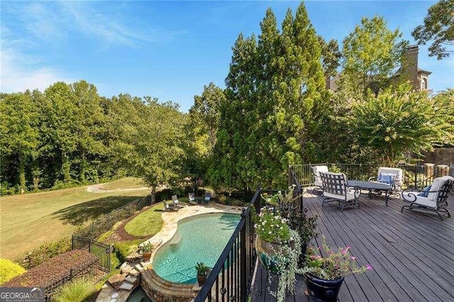 wooden terrace featuring a yard and a fenced in pool