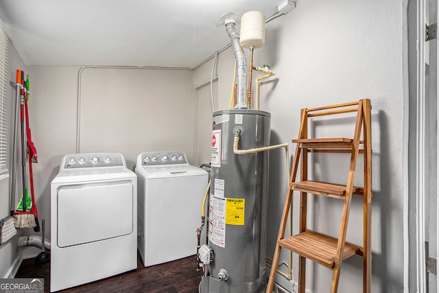 clothes washing area featuring gas water heater, independent washer and dryer, and dark hardwood / wood-style flooring