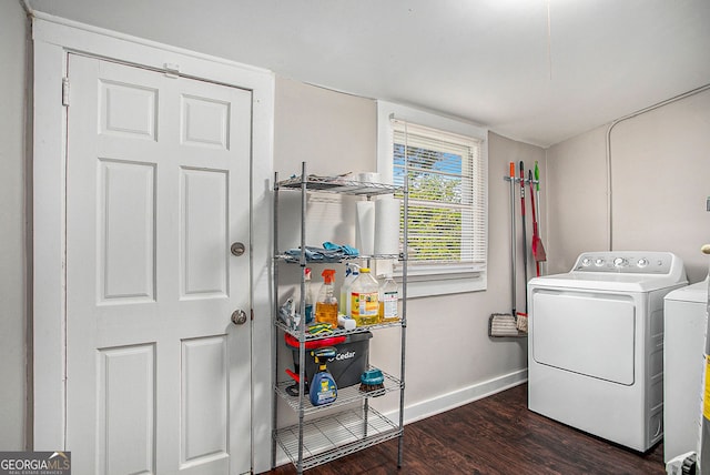 laundry room featuring washer and dryer, water heater, and dark wood-type flooring