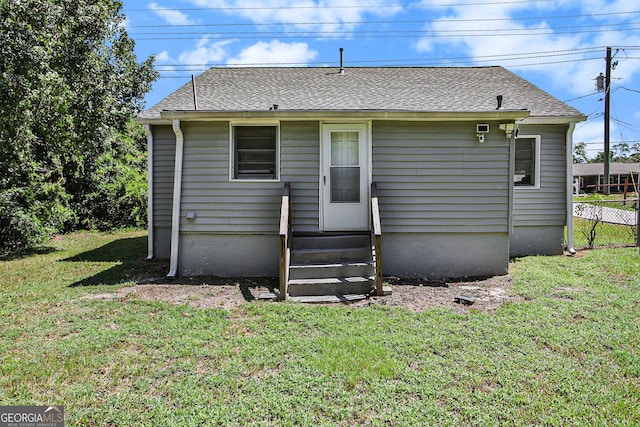 back of property featuring a yard