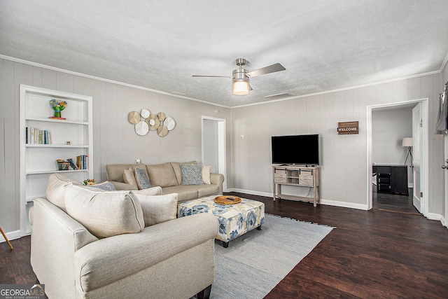 living room featuring dark hardwood / wood-style floors, ornamental molding, a textured ceiling, and ceiling fan