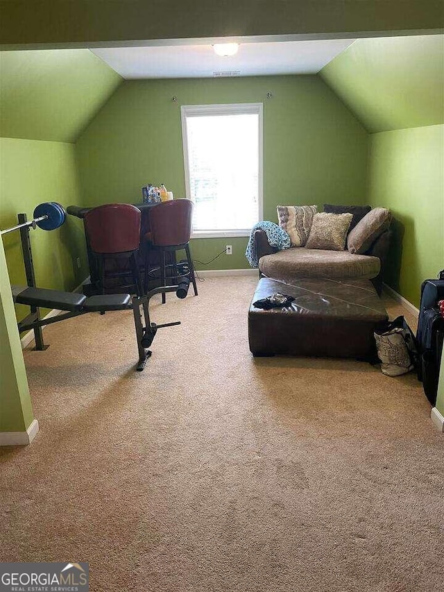 interior space with vaulted ceiling and carpet floors