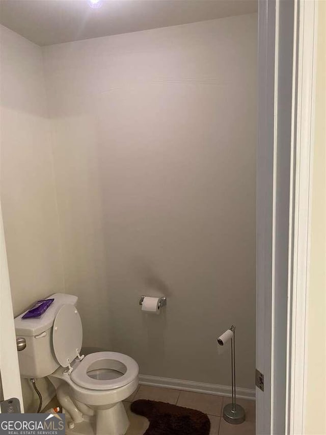 bathroom with toilet and tile patterned floors