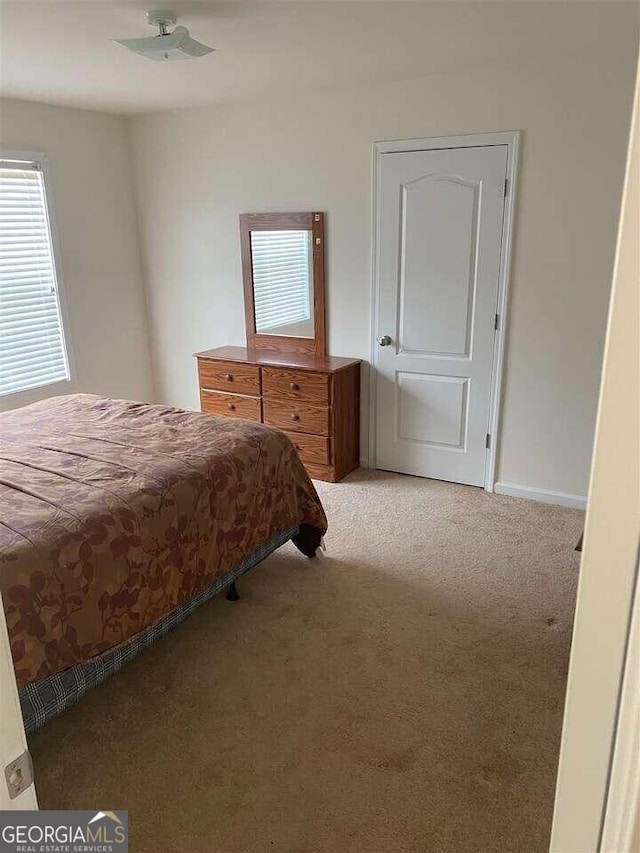 bedroom with light colored carpet