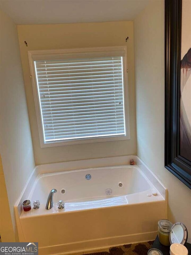 bathroom featuring a wealth of natural light and a tub