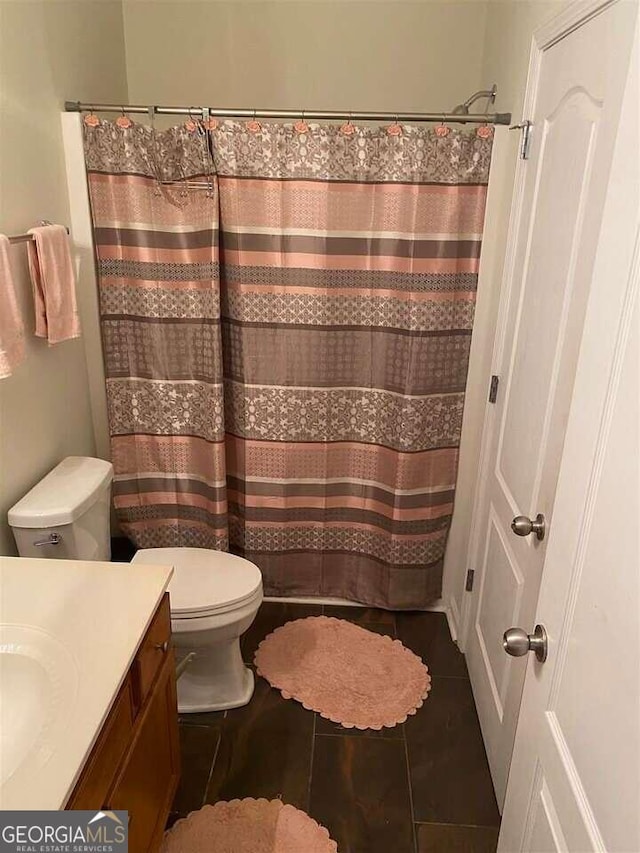 bathroom featuring vanity, toilet, a shower with curtain, and tile patterned flooring