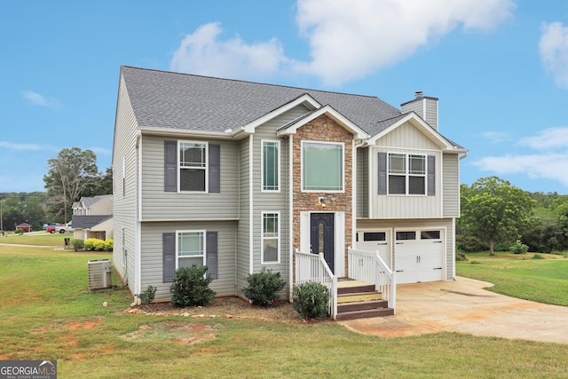 split foyer home with driveway, a front yard, a garage, central AC unit, and a chimney