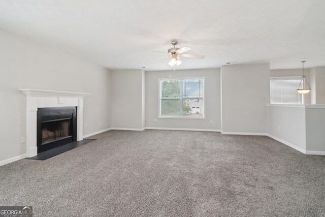 unfurnished living room with carpet flooring and ceiling fan