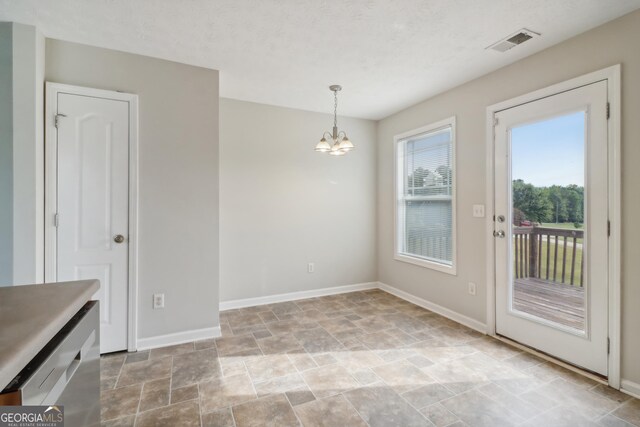 unfurnished dining area with a chandelier