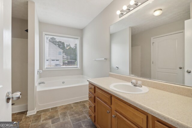 bathroom featuring a tub and vanity