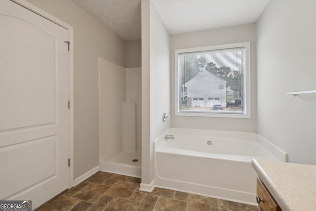 full bathroom with a garden tub, baseboards, walk in shower, and vanity