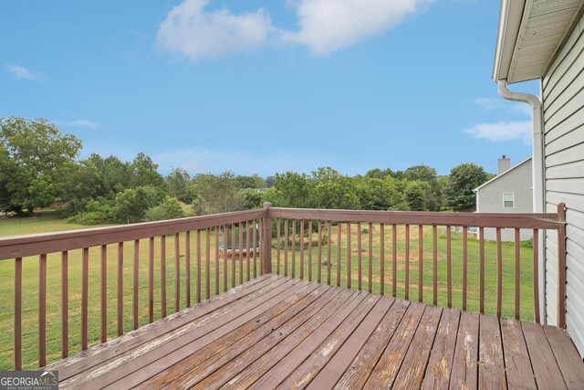 wooden terrace with a lawn