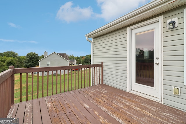 wooden terrace with a lawn