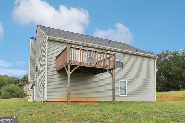 back of house with a yard and a wooden deck