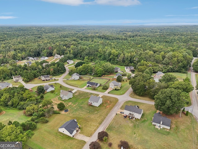 drone / aerial view featuring a forest view