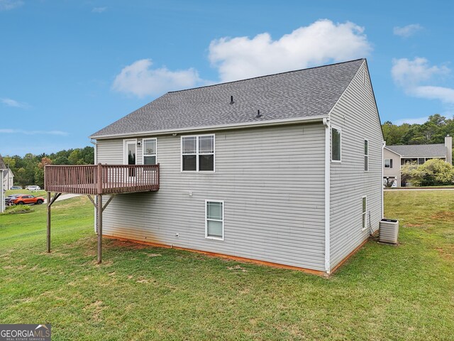 back of house featuring a lawn and central AC unit