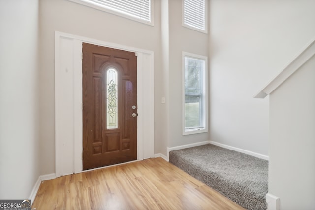 entryway with a high ceiling and hardwood / wood-style floors