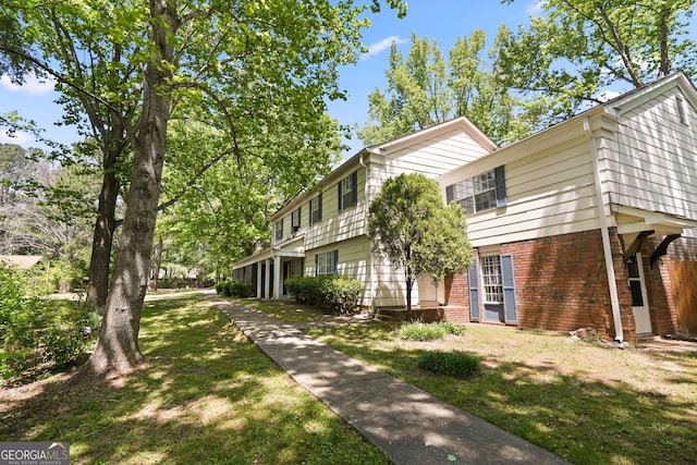 view of property exterior with a yard