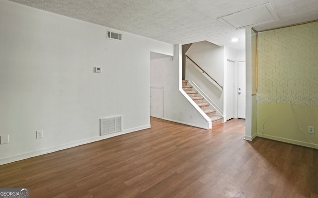 interior space with dark hardwood / wood-style floors and a textured ceiling