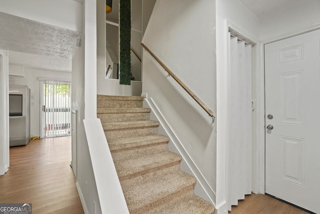 stairway with hardwood / wood-style flooring