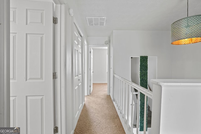 hall with light colored carpet