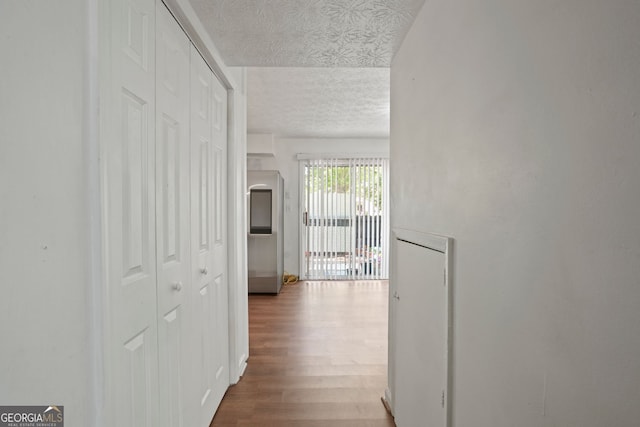 corridor with hardwood / wood-style floors