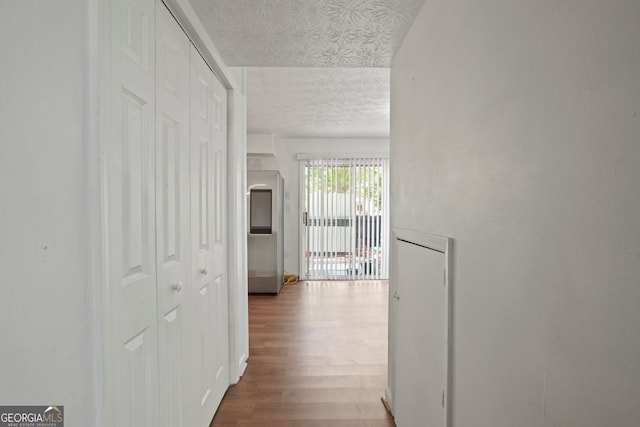 6584 Sleepy Hollow Ln, Morrow, GA 30260 - spare room with wood finished floors, baseboards, and a textured ceiling