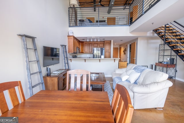 dining area featuring a high ceiling