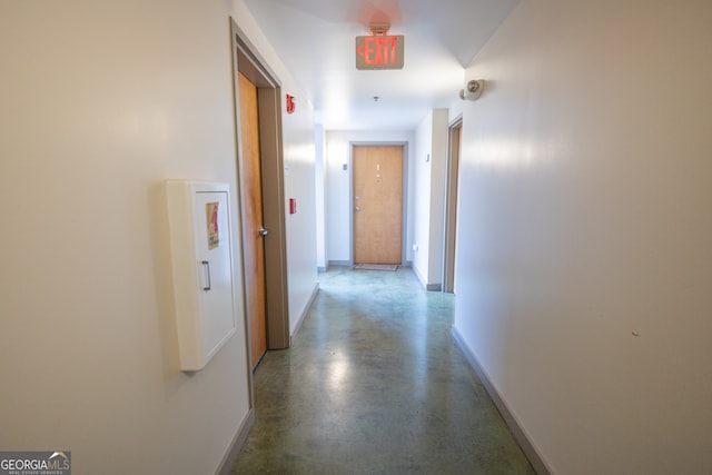 hall featuring concrete floors