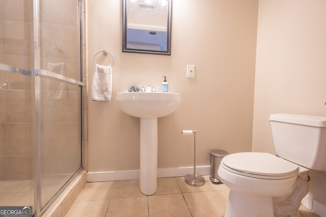 bathroom with walk in shower, toilet, and tile patterned flooring