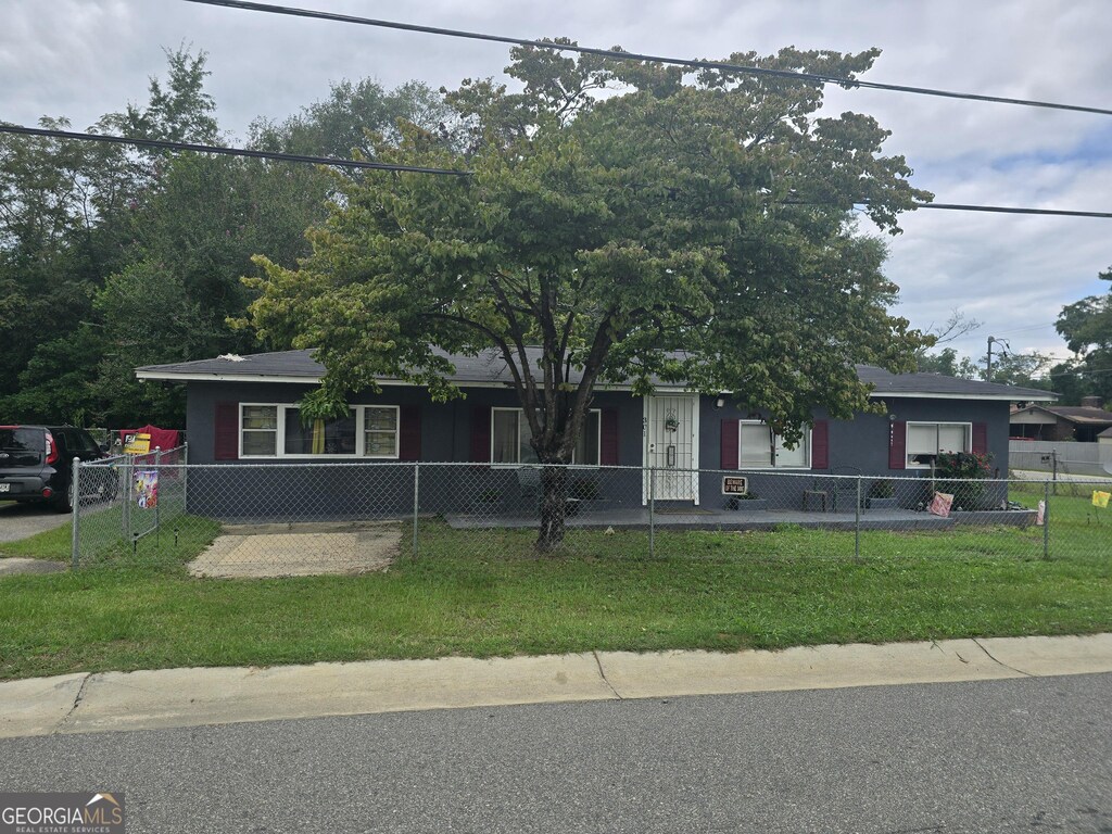 view of front of house with a fenced front yard and a front lawn