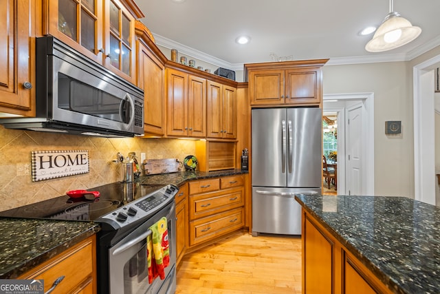 kitchen with decorative light fixtures, light hardwood / wood-style flooring, tasteful backsplash, crown molding, and stainless steel appliances