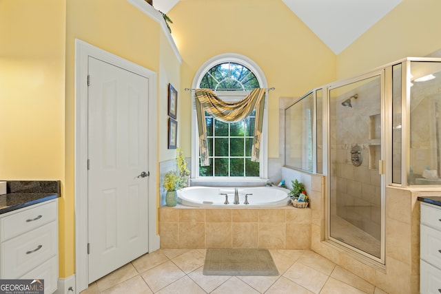 bathroom featuring lofted ceiling, tile patterned floors, plus walk in shower, and vanity