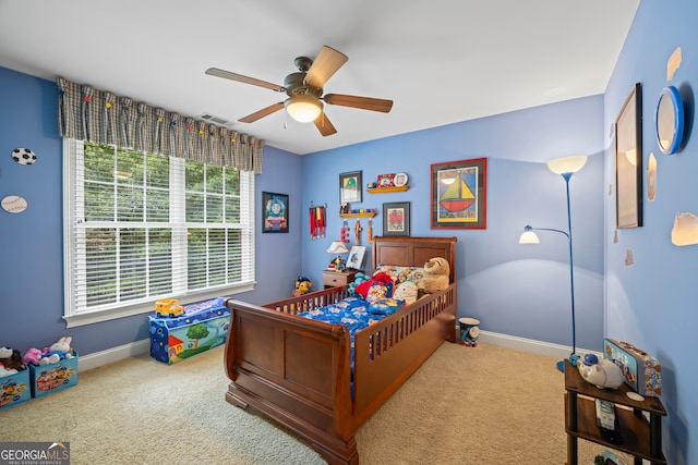 bedroom with carpet flooring, ceiling fan, and multiple windows