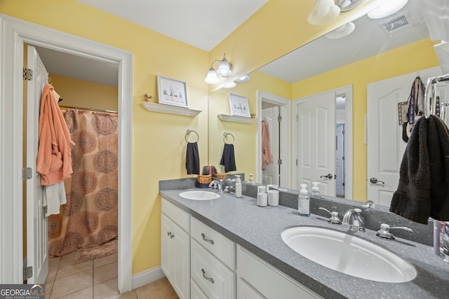 bathroom with tile patterned flooring, walk in shower, and vanity