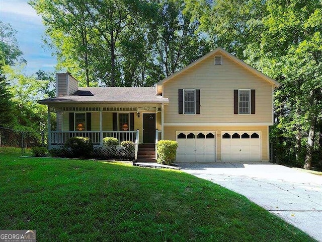 split level home featuring a front lawn, a garage, and a porch