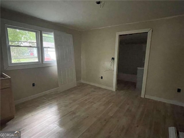 spare room featuring wood-type flooring