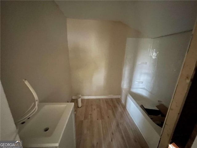 bathroom featuring hardwood / wood-style floors and independent shower and bath