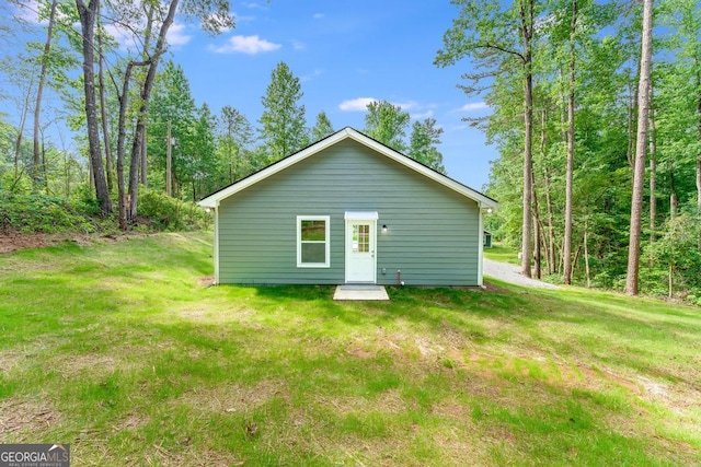 rear view of property featuring a yard