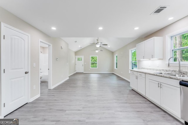 kitchen with light hardwood / wood-style floors, white cabinetry, sink, lofted ceiling, and ceiling fan