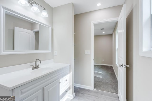 bathroom with hardwood / wood-style floors and vanity